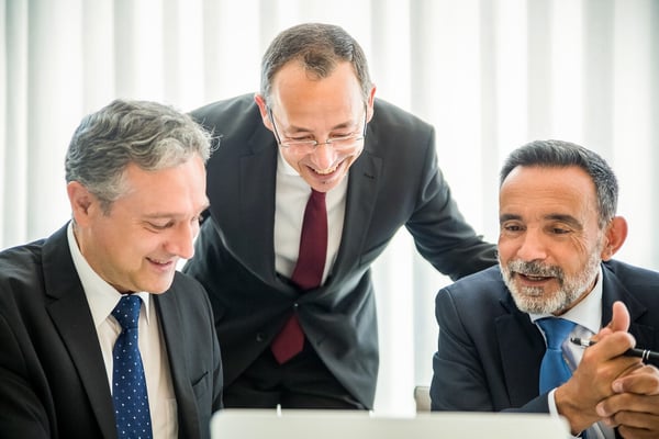 Three-senior-executives-reviewing-a-document-on-a-computer.